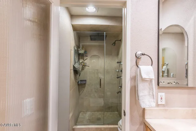 a bathroom with a tub shower and sink
