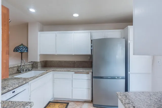 a kitchen with a refrigerator and a sink
