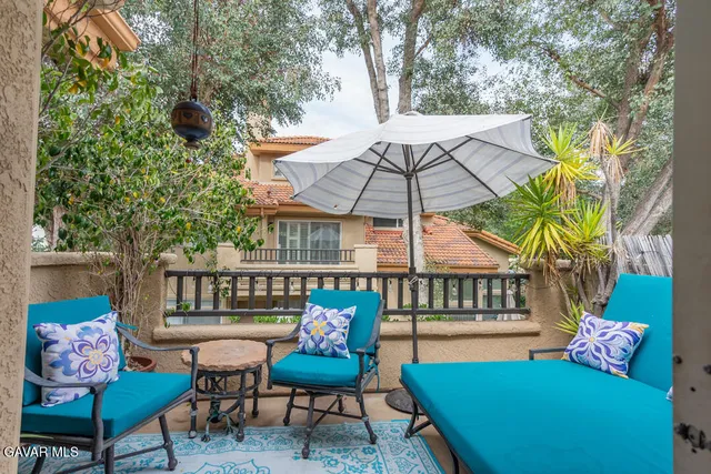 a view of a chairs and table in the patio