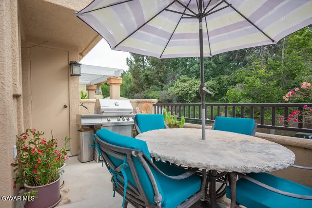a view of a chairs and table under an umbrella