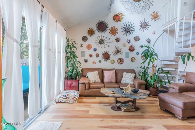 a living room with furniture and flowers