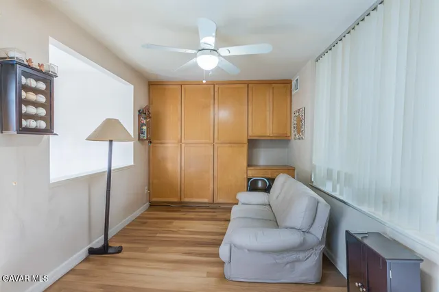 a living room with furniture and a ceiling fan