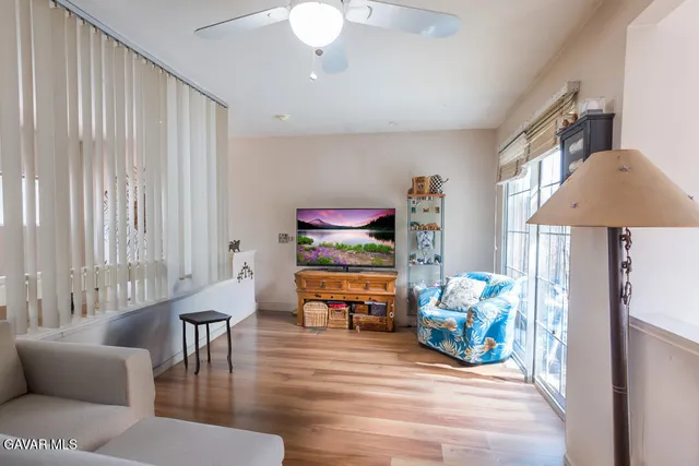 a living room with furniture and wooden floor