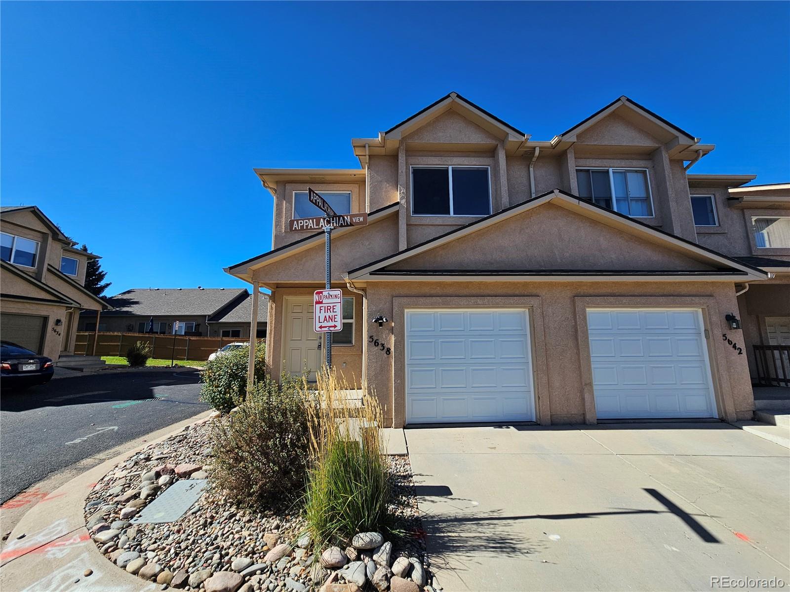 5638 Appalachian View Colorado Springs, CO 80918 - Photo 1 of 21 a front view of a house with a yard