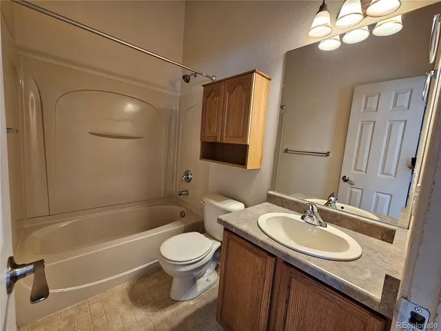 an empty room with window and fan