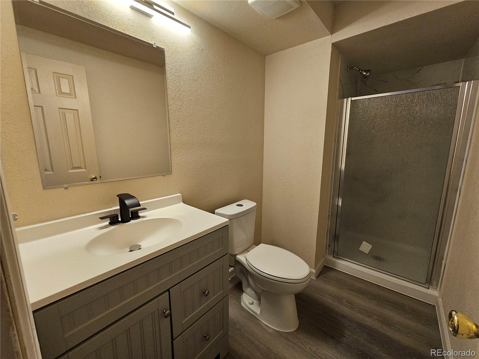 5638 Appalachian View Colorado Springs, CO 80918 - Photo 20 of 21 a bathroom with a sink a toilet and shower