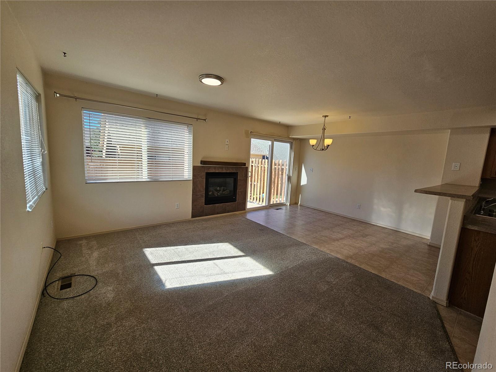 5638 Appalachian View Colorado Springs, CO 80918 - Photo 5 of 21 a view of an empty room with a fireplace and a window