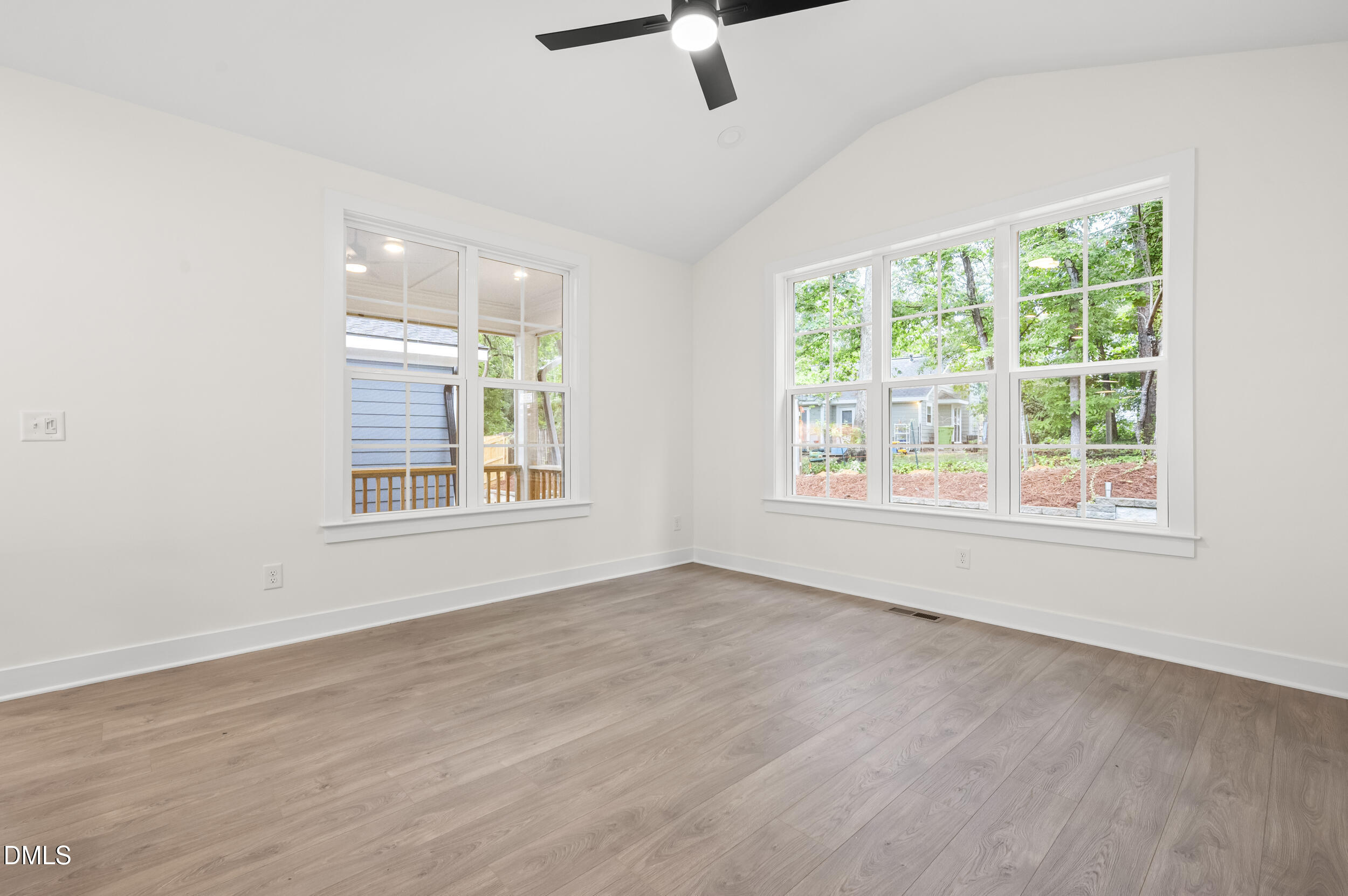 708 Grayhaven Place Raleigh, NC 27606 - Photo 11 of 33 a view of an empty room with a window and wooden floor