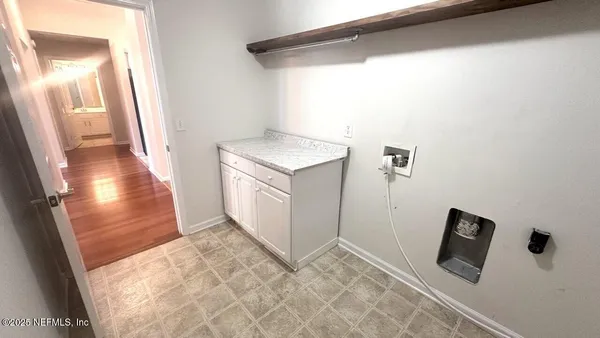 a view of a hallway with washer and dryer