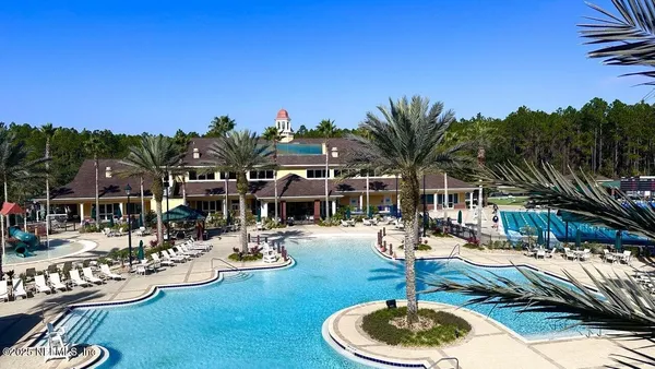 a view of a swimming pool with outdoor seating