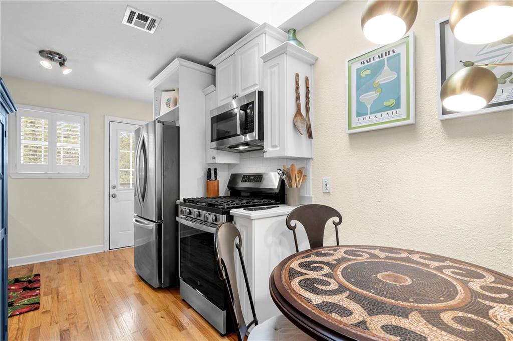 1879 Johnson Road Northeast, Unit 5 Atlanta, GA 30306 - Photo 13 of 28 a kitchen with stainless steel appliances granite countertop a stove a sink and a refrigerator