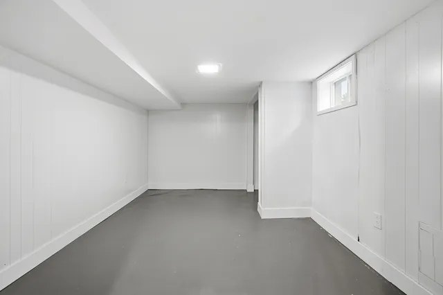 an empty room with a empty space and windows