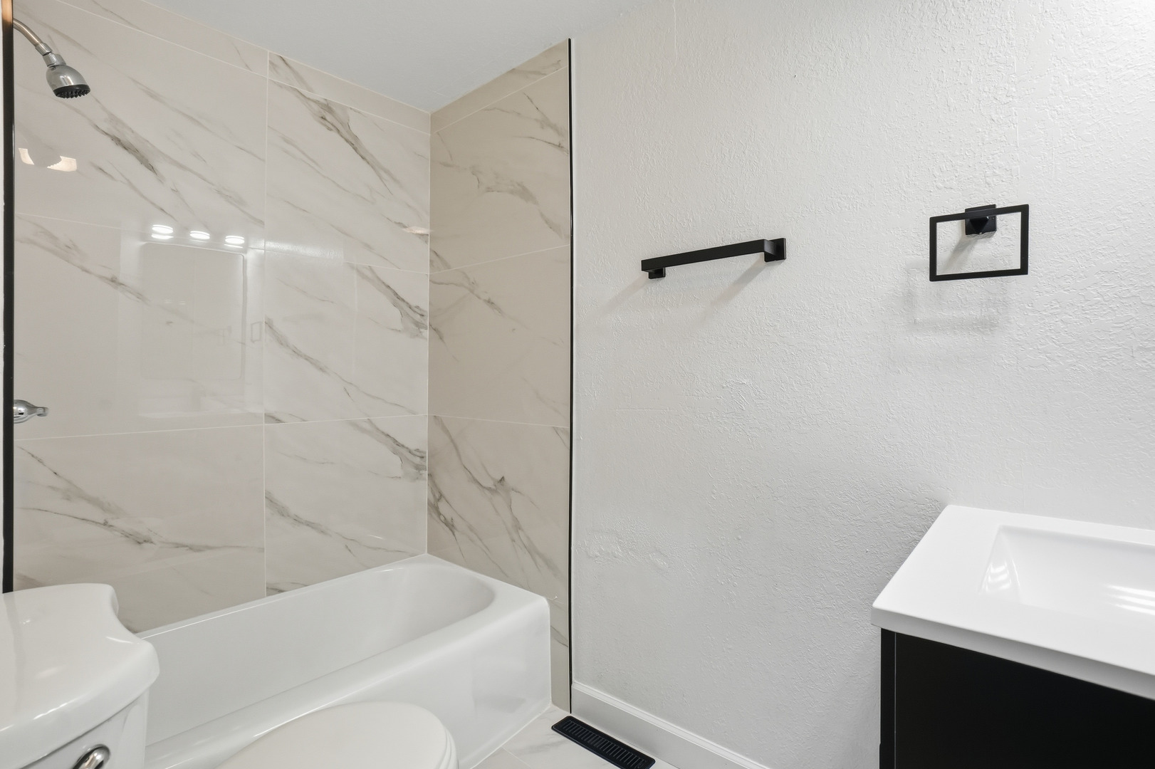 446 South Jackson Street Waukegan, IL 60085 - Photo 6 of 20 a bathroom with a bathtub a toilet and a sink