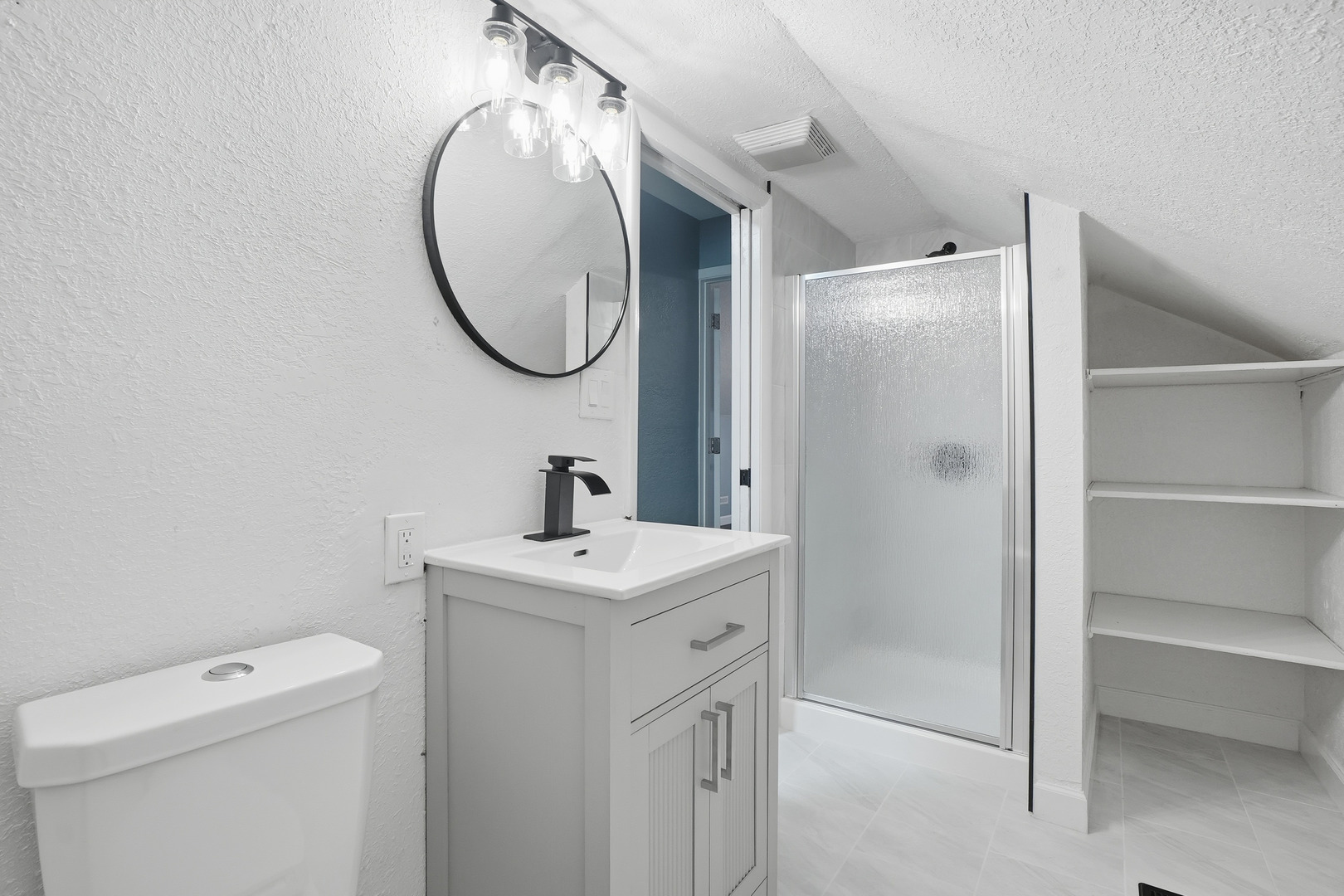 446 South Jackson Street Waukegan, IL 60085 - Photo 7 of 20 a bathroom with a sink a toilet and a mirror
