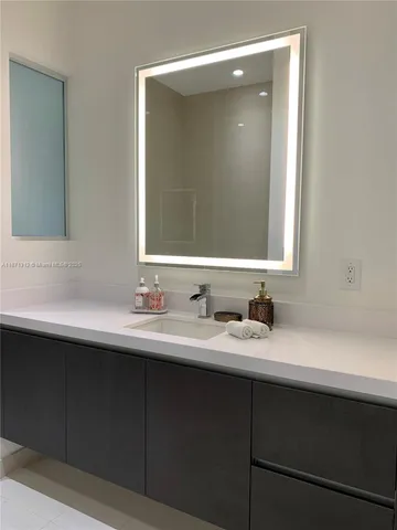 a bathroom with a double vanity sink and mirror