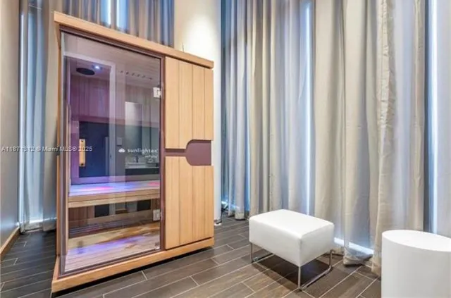 a dining room with wooden floor a glass table and chairs