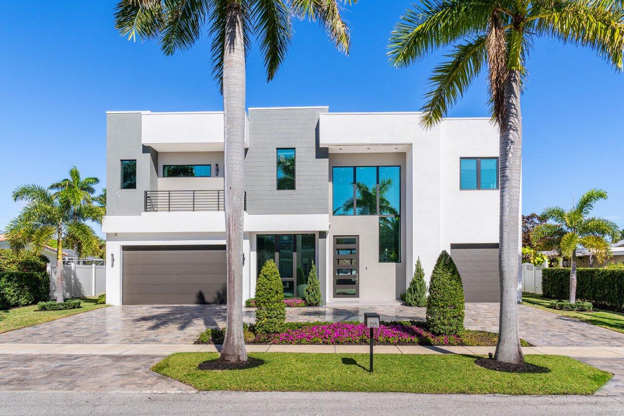 725 Northeast 71st Street Boca Raton, FL 33487 - Photo 63 of 66 a front view of multi story residential apartment building with yard and sign board
