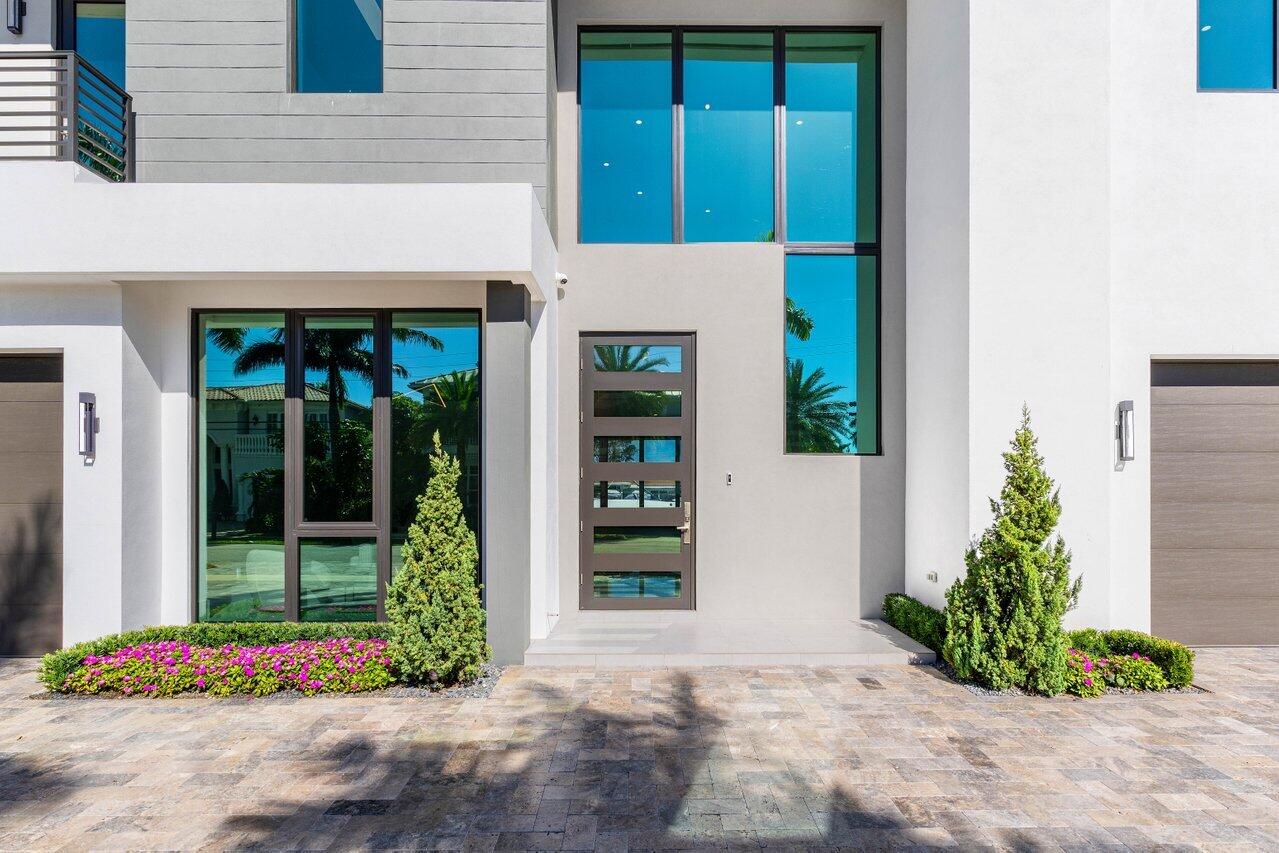 725 Northeast 71st Street Boca Raton, FL 33487 - Photo 10 of 66 a front view of a house with entryway