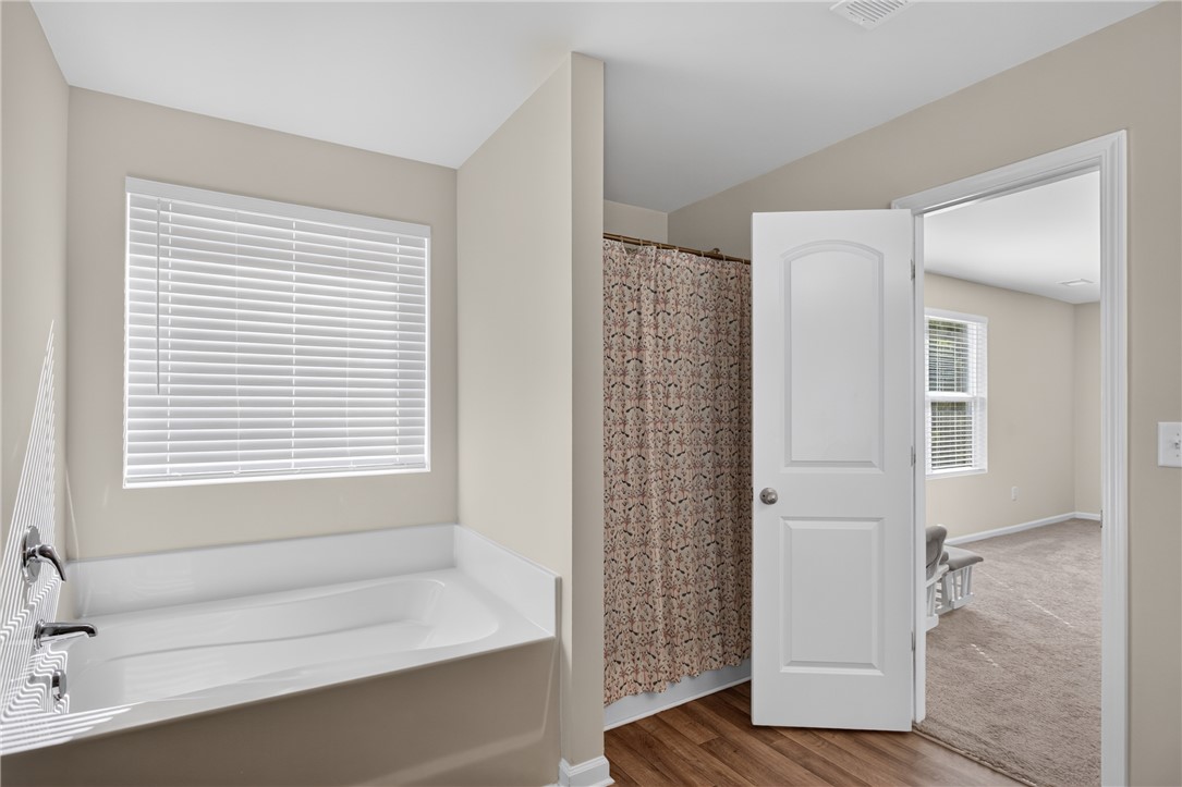 1081 Edenbrooke Circle Anderson, SC 29621 - Photo 26 of 46 An inviting full bathroom with a deep tub and a spacious shower.