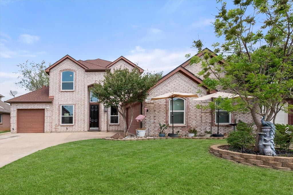 1305 Liverpool Lane Mansfield, TX 76063 - Photo 1 of 40 The property features a brick exterior, an attached garage with a brown door, and a well-maintained lawn
