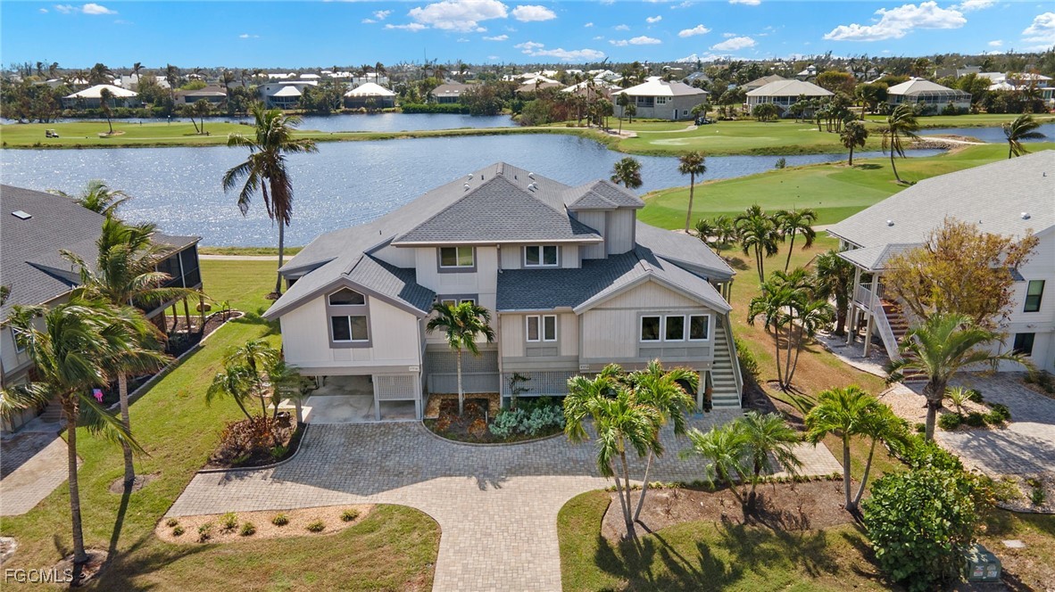 an aerial view of a house with outdoor space and lake view