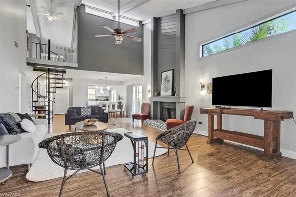 a view of a livingroom with furniture and a flat screen tv