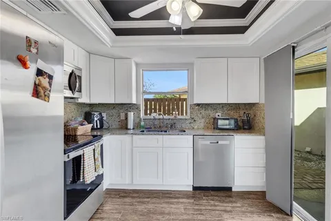 a kitchen with stainless steel appliances granite countertop a stove a sink and a refrigerator