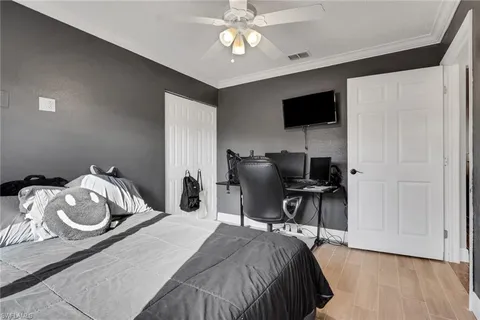 a bedroom with a bed and a flat screen tv