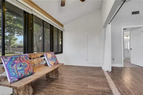 a living room with furniture and large window