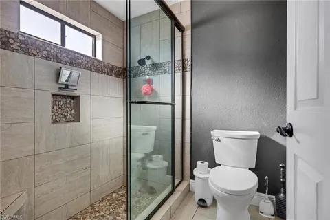 a bathroom with a toilet and a shower