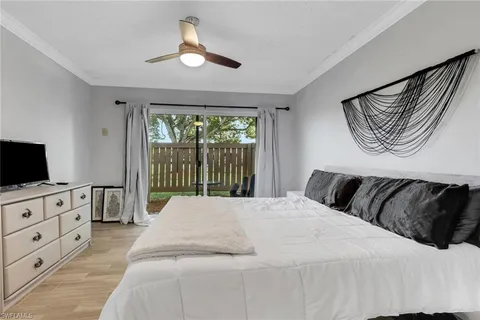 a bedroom with a bed and a television