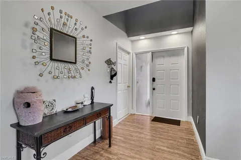 a room with painting on the wall and a table