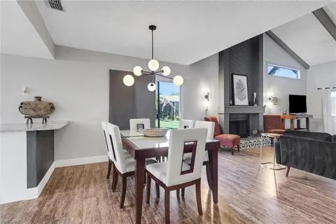 a view of a dining room with furniture wooden floor and chandelier