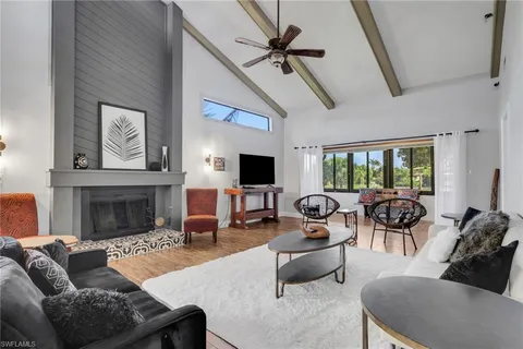 a living room with furniture fireplace and a flat screen tv