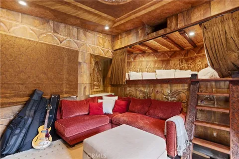 an aerial view of residential house with parking space and covered with trees