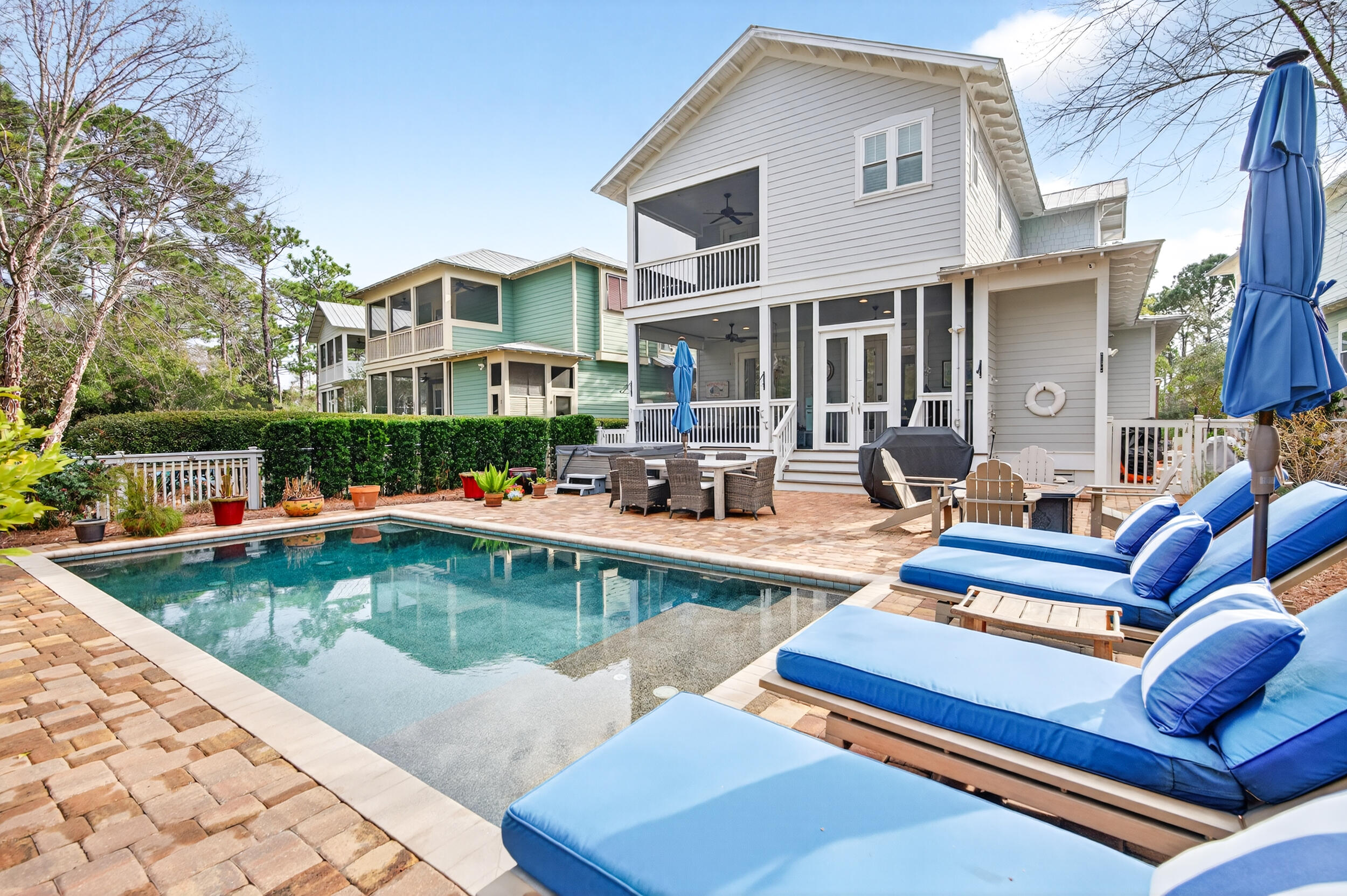563 Sandgrass Boulevard Santa Rosa Beach, FL 32459 - Photo 1 of 73 a view of a patio with couches chairs and swimming pool with a yard