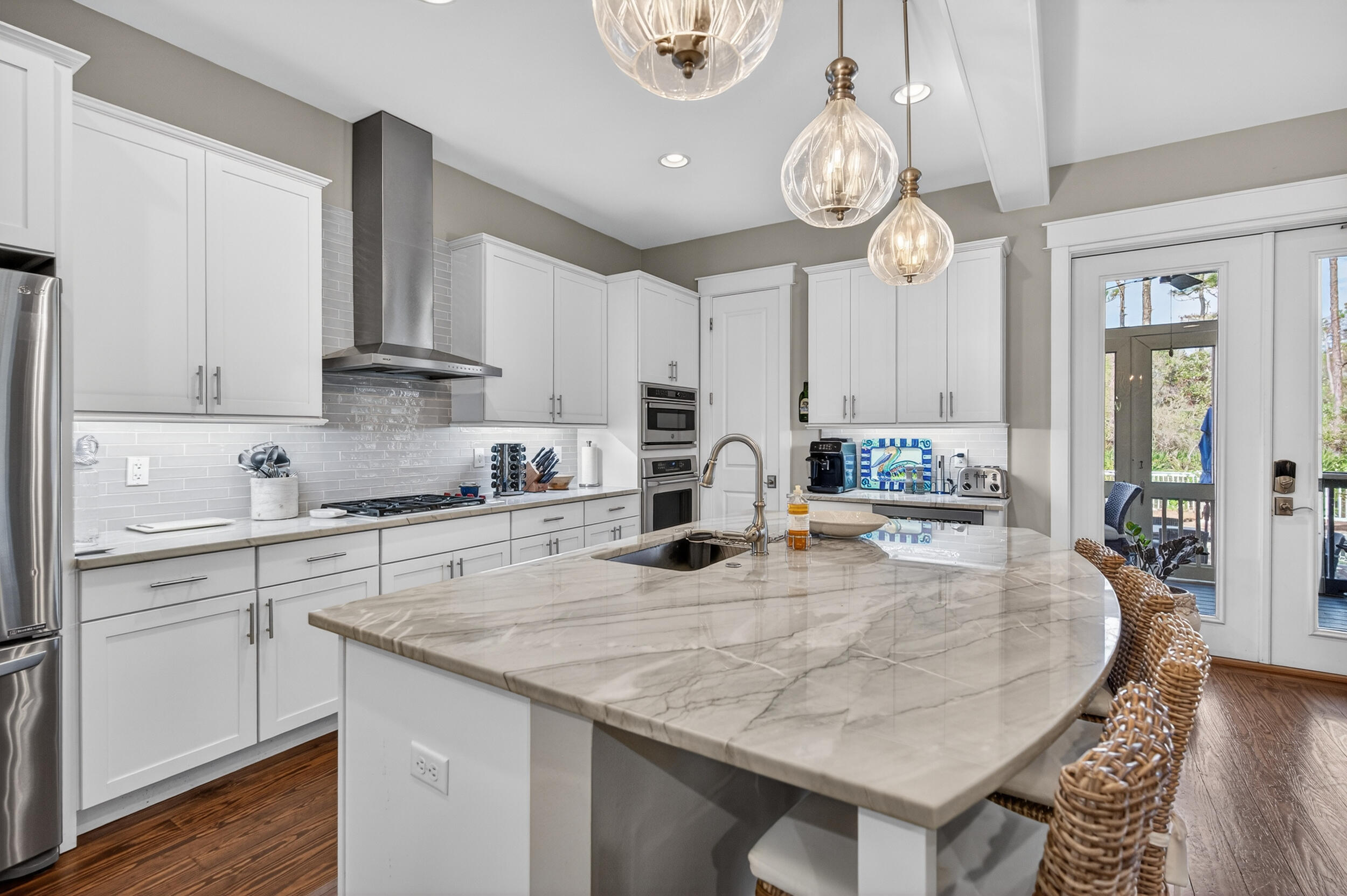 563 Sandgrass Boulevard Santa Rosa Beach, FL 32459 - Photo 14 of 73 a kitchen with stainless steel appliances granite countertop a sink a stove and cabinets