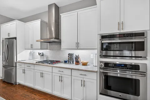 a view of a dining room with furniture large windows and wooden floor