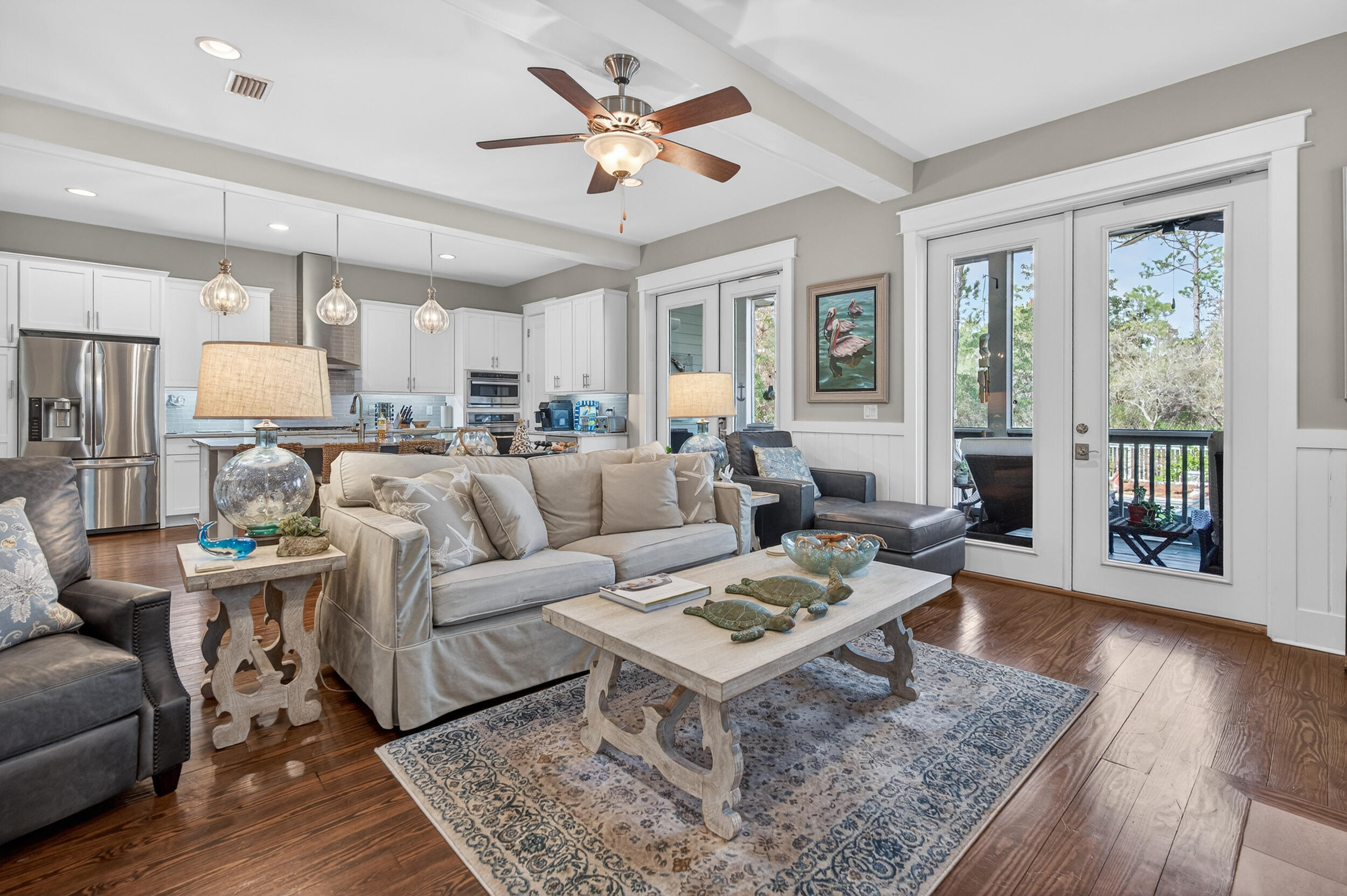 563 Sandgrass Boulevard Santa Rosa Beach, FL 32459 - Photo 21 of 73 a living room with furniture a large window and wooden floor
