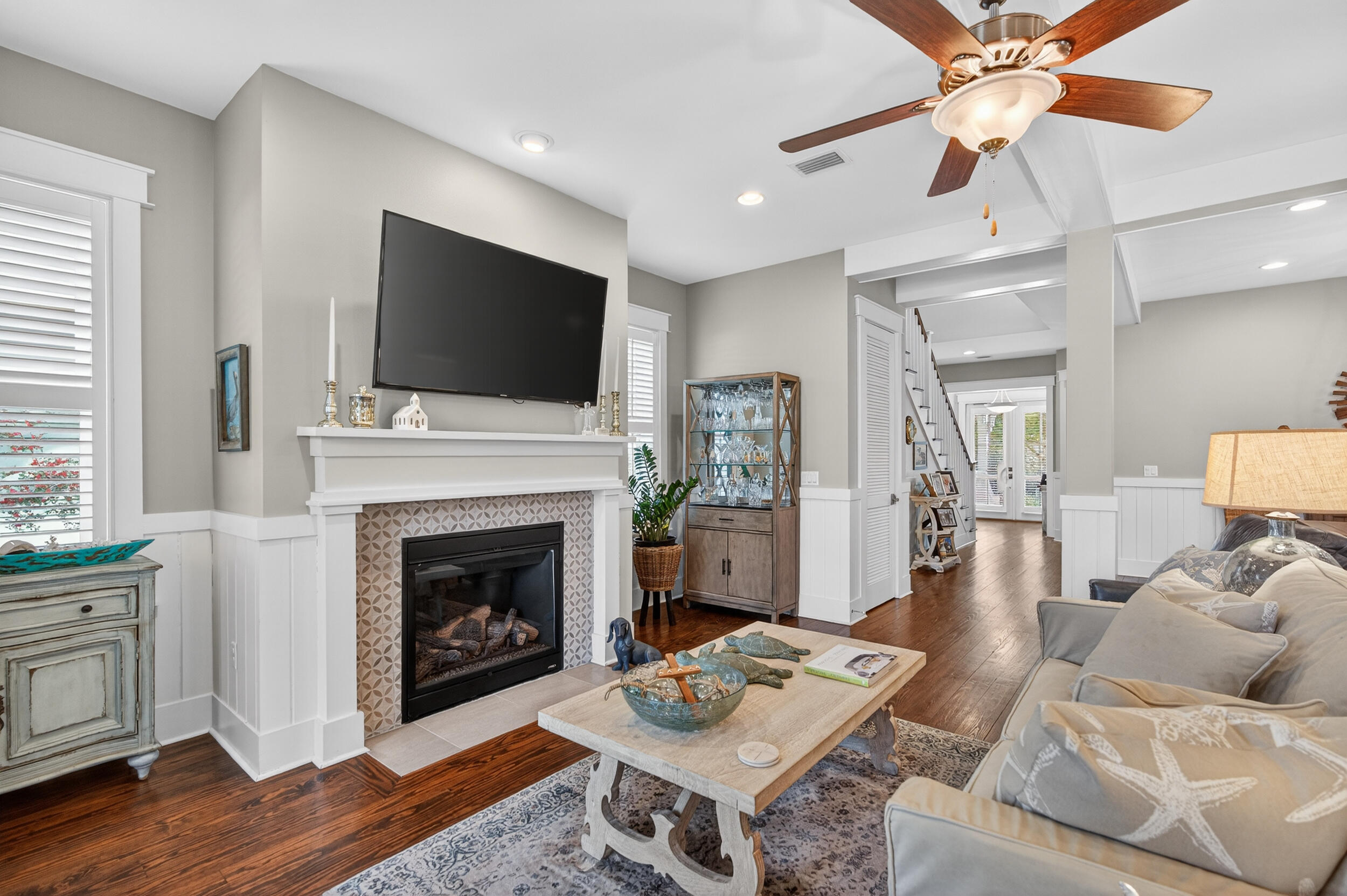 563 Sandgrass Boulevard Santa Rosa Beach, FL 32459 - Photo 23 of 73 a living room with furniture a flat screen tv and a fireplace