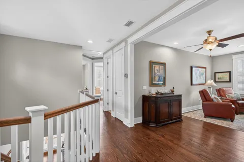 a living room with furniture a couch and wooden floor