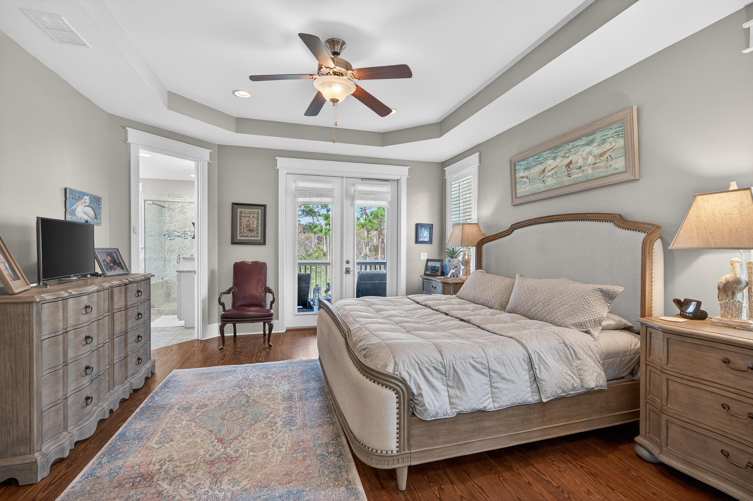 563 Sandgrass Boulevard Santa Rosa Beach, FL 32459 - Photo 32 of 73 a bedroom with a large bed a flat tv screen and a chandelier