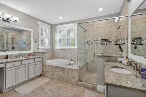 a bathroom with a granite countertop sink a toilet and mirror