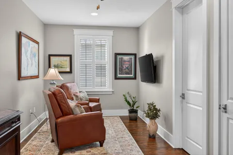 a view of a patio with couches table and chairs and potted plants