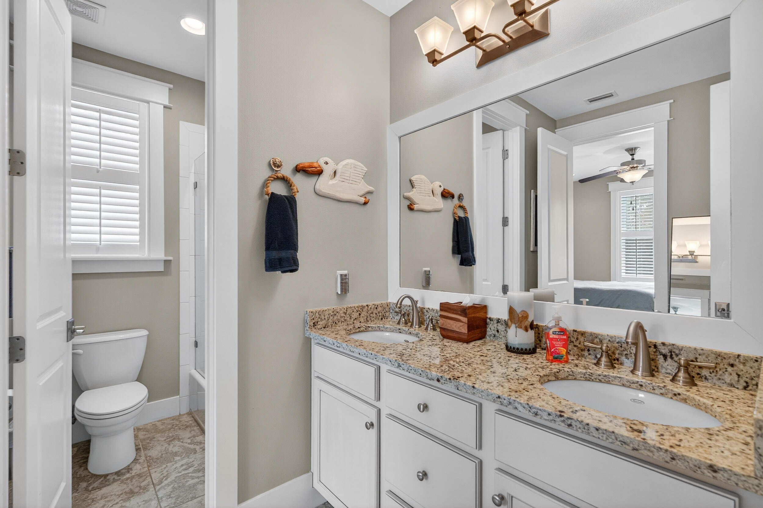563 Sandgrass Boulevard Santa Rosa Beach, FL 32459 - Photo 45 of 73 a bathroom with a granite countertop sink a toilet and mirror