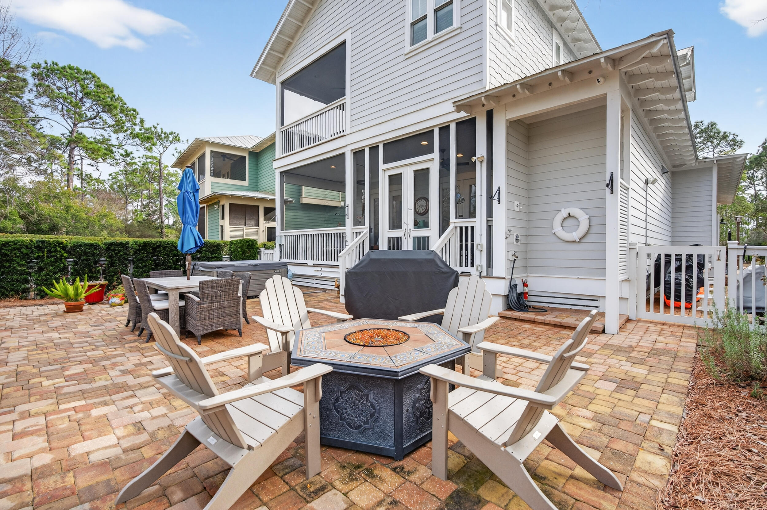563 Sandgrass Boulevard Santa Rosa Beach, FL 32459 - Photo 52 of 73 a view of a patio with couches table and chairs and potted plants