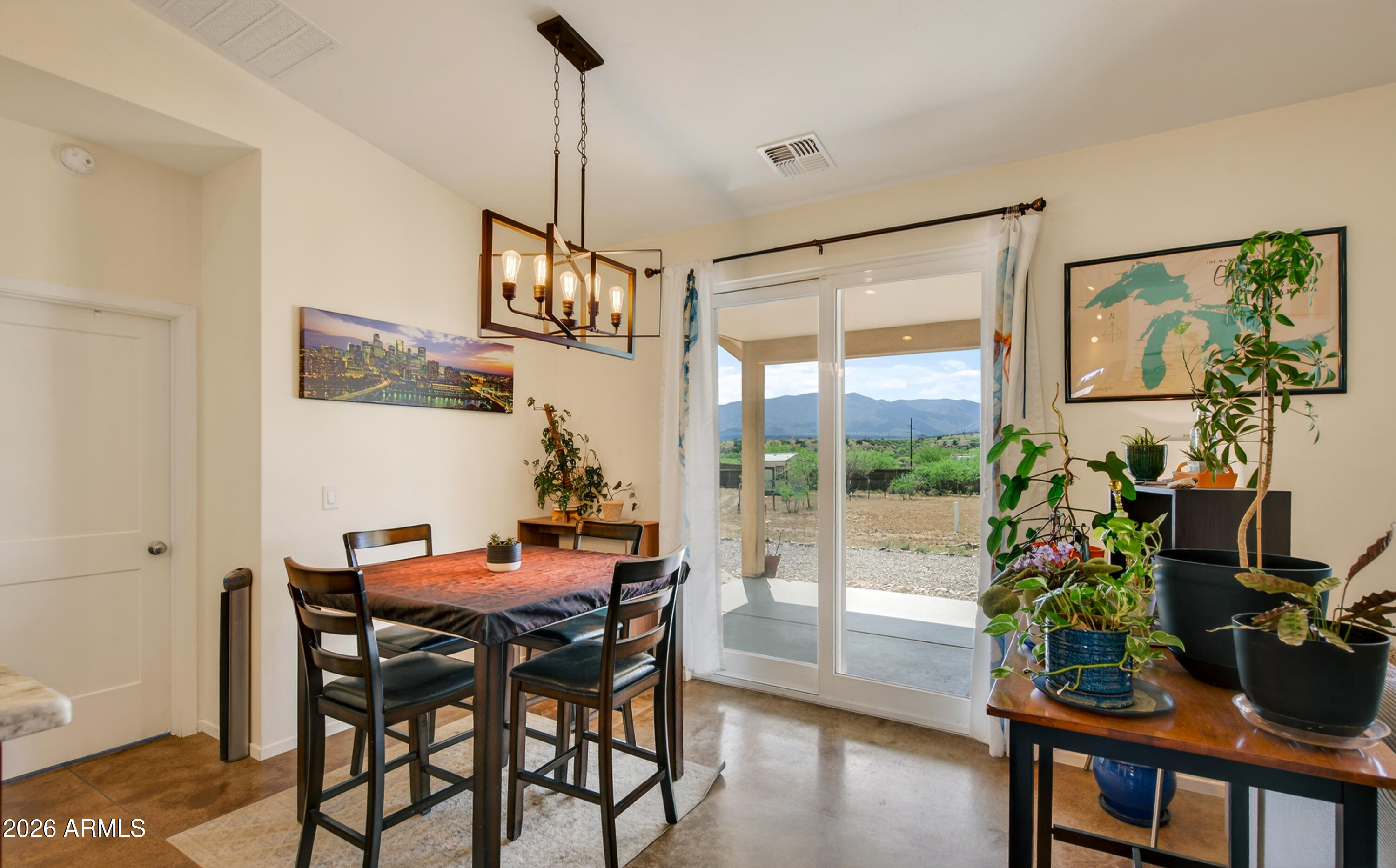 2771 South Country Hill Road Cornville, AZ 86325 - Photo 27 of 48 a dining room with furniture potted plants and wooden floor