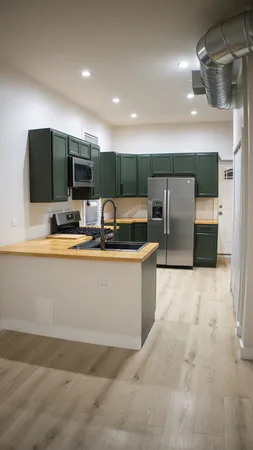 a kitchen with a refrigerator and a stove top oven