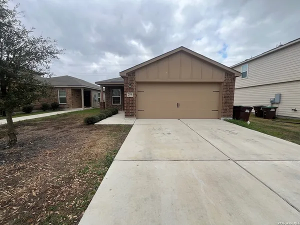 a front view of house with yard and trees around