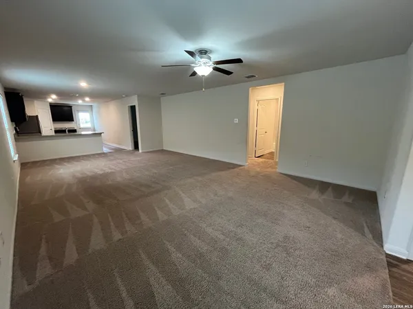 a view of a livingroom with a ceiling fan and window